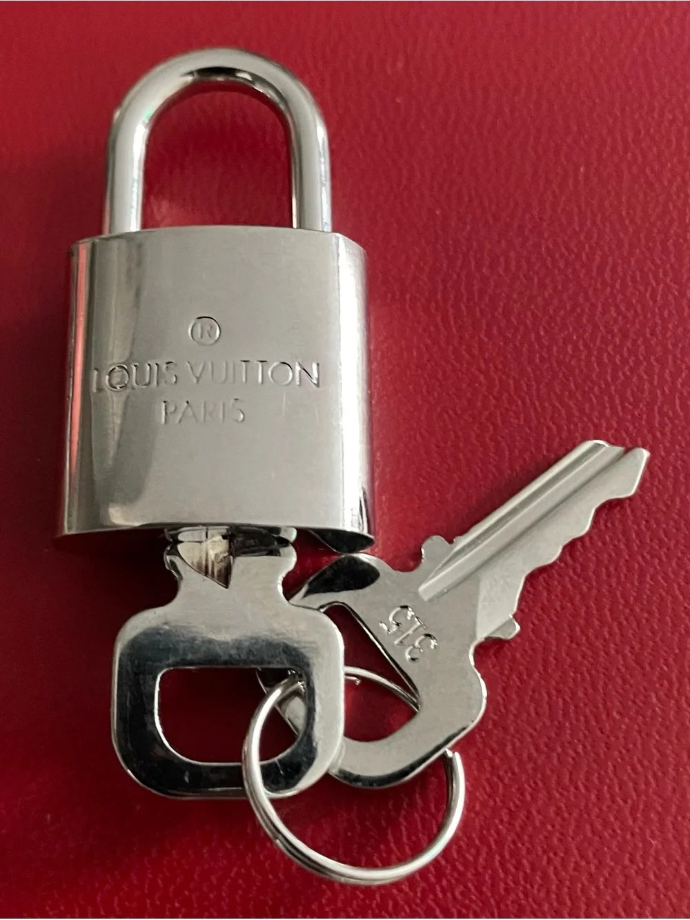 Louis Vuitton Silver Padlock and Keys on Red